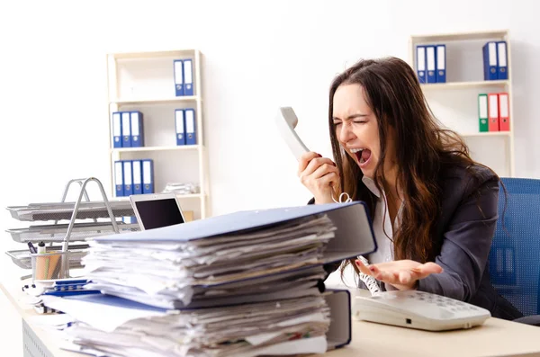 Young female employee unhappy with excessive work — Stock Photo, Image