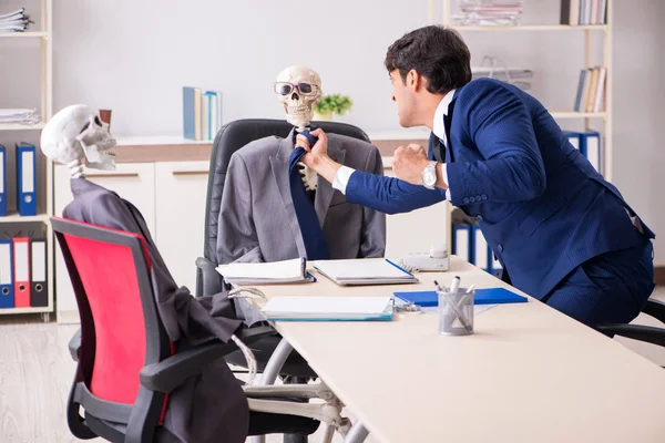 Funny business meeting with boss and skeletons