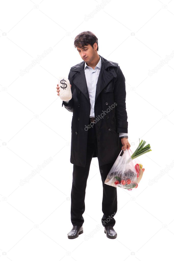 Young handsome man with vegatables in shopping concept 