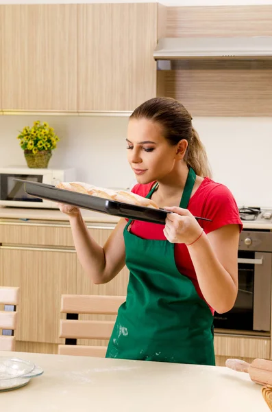 Young female baker working in kitchen — Stock Photo, Image