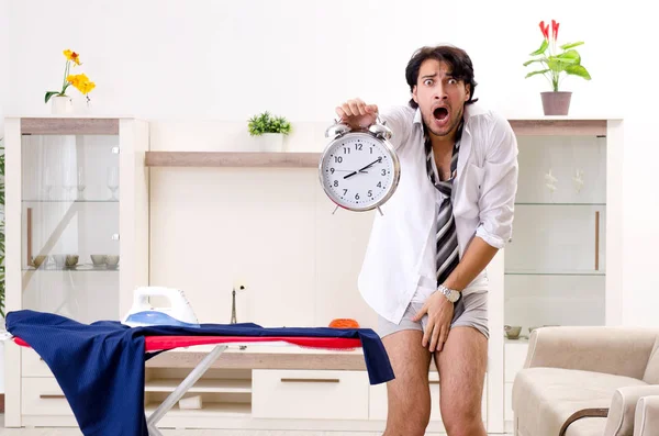 Young man ironing in the bedroom — Stock Photo, Image