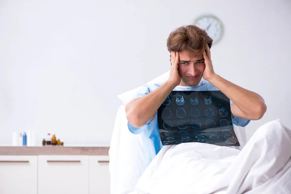 Young male patient lying on couch in hospital