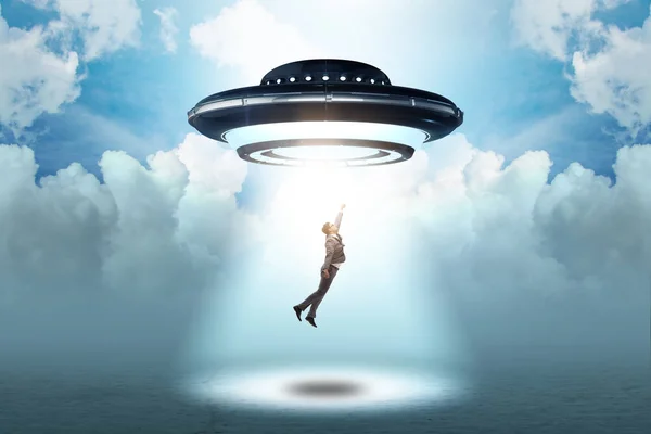 Flying saucer abducting young businessman