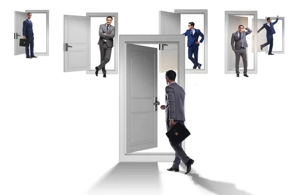 Businessman in uncertainty concept with many doors — Stock Photo, Image