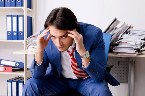 Young businessman employee unhappy with excessive work — Stock Photo, Image