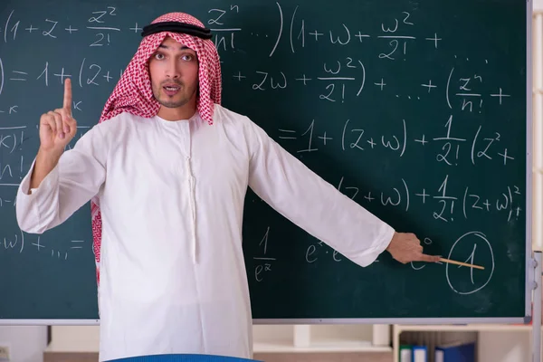 Arab teacher in front of chalkboard — Stock Photo, Image