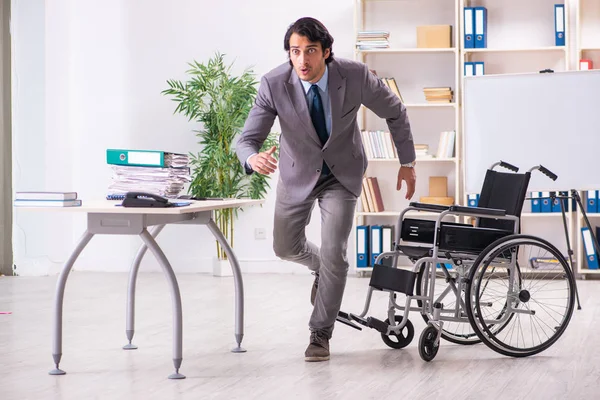 事務所で車椅子では若いハンサムな従業員 — ストック写真