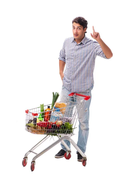 Молодой человек с тележкой в супермаркете на белом — стоковое фото