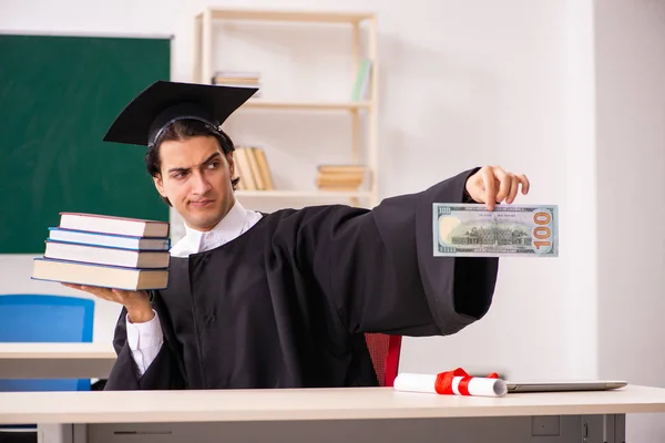 Graduate student in front of green board — Stock Photo, Image