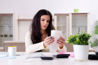 Young woman with receipts in budget planning concept  clipart