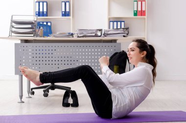 Kadın işçilerin ofiste spor egzersizleri yapıyor 