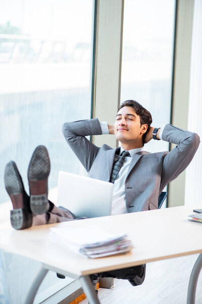 Young successful businessman working at the office 