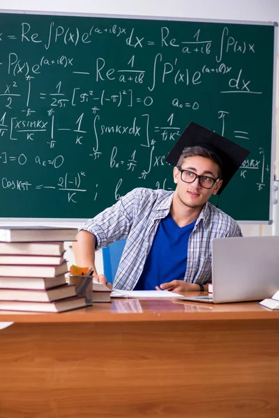 Young male student studying math at school — Stock Photo, Image