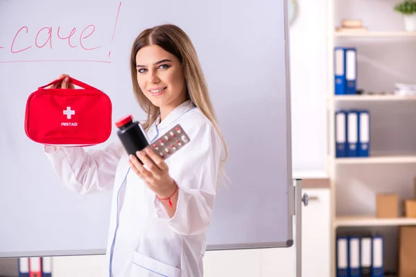 Doctora joven de pie frente a la pizarra blanca —  Fotos de Stock