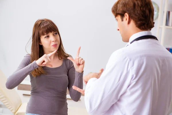 Deaf-mute female patient visiting young male doctor — Stock Photo, Image