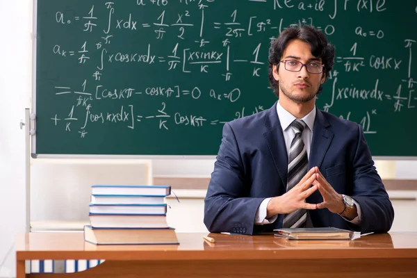 Young male math teacher in classroom — Stock Photo, Image