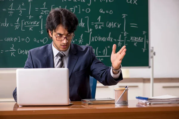 Young male math teacher in classroom — Stock Photo, Image