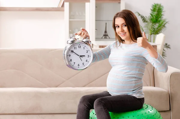 Mujer embarazada joven haciendo ejercicios deportivos en casa — Foto de Stock