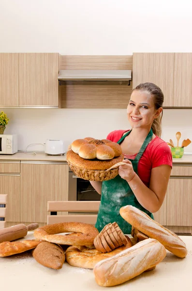 Young female baker working in kitchen — Stock Photo, Image