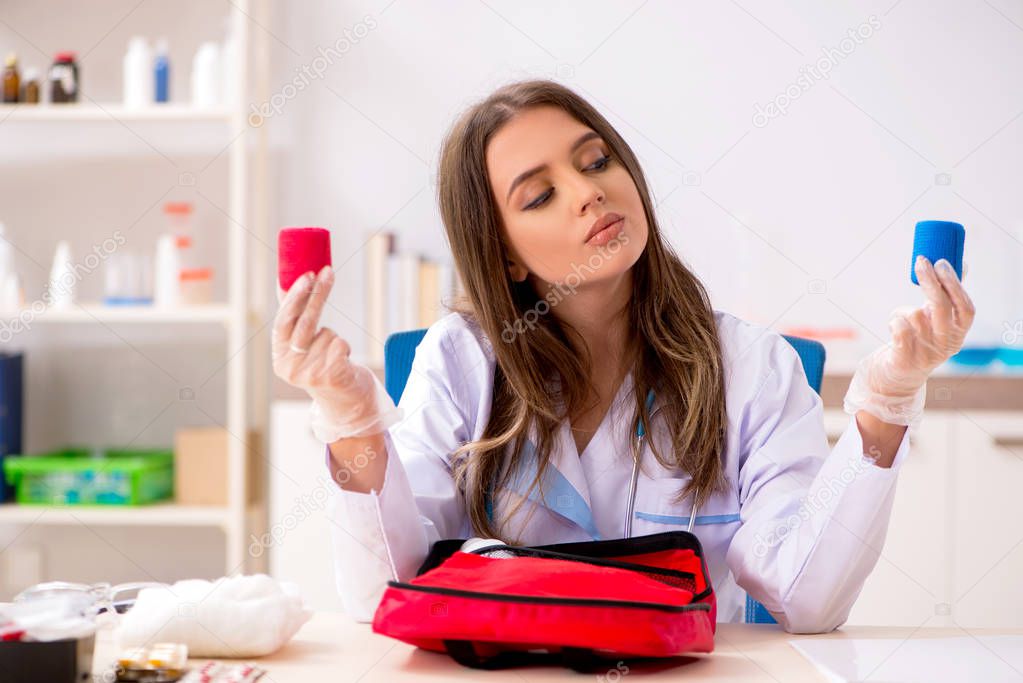 Female beautiful doctor with first aid bag 