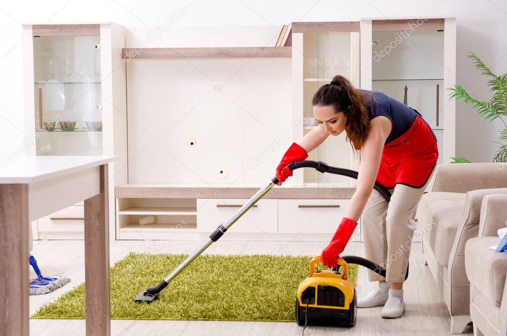 Young beautiful woman cleaning apartment 