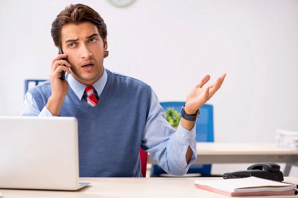 Young handsome employee working in the office — Stock Photo, Image