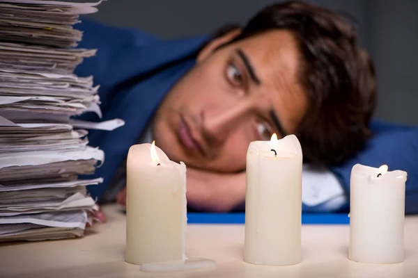 Businessman working late in office with candle light — Stock Photo, Image