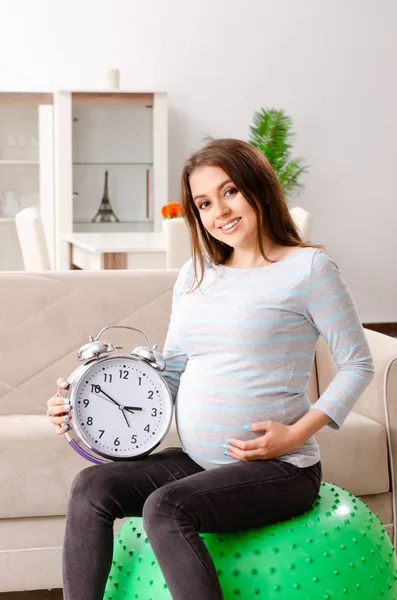 Young pregnant woman doing sport exercises at home — Stock Photo, Image