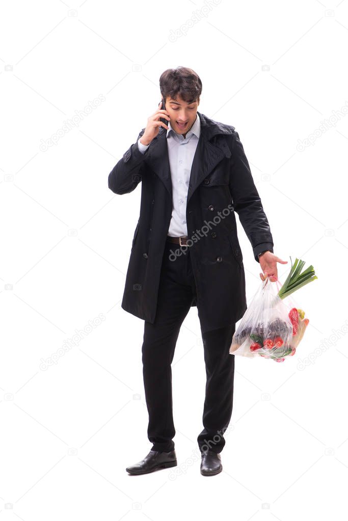 Young handsome man with vegatables in shopping concept 