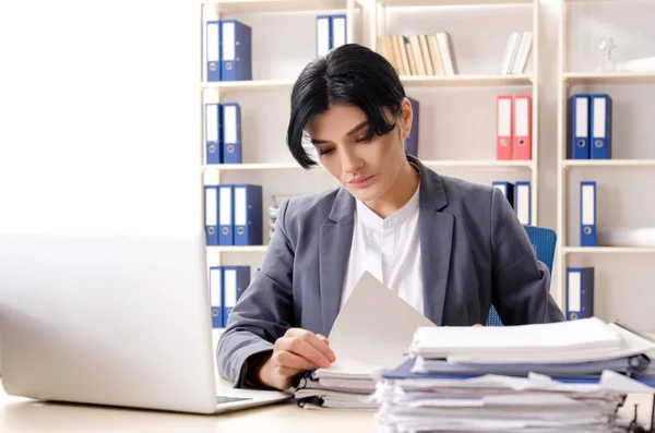 Middle aged businesslady unhappy with excessive work — Stock Photo, Image