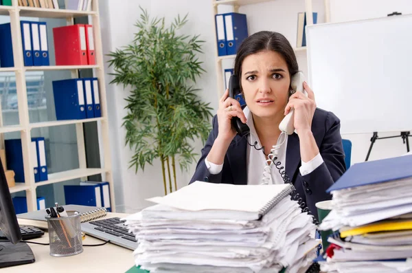 Funcionário feminino com muito trabalho no escritório — Fotografia de Stock