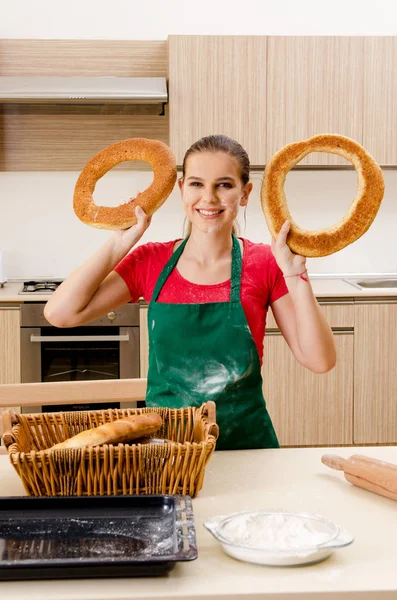 Young female baker working in kitchen