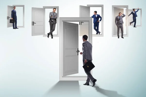 Businessman in uncertainty concept with many doors — Stock Photo, Image