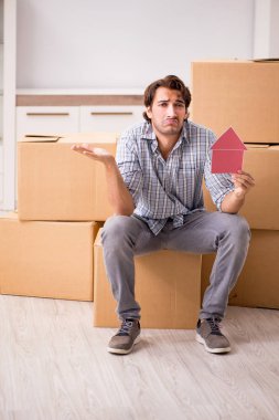 Young man offering home for sale and moving out  clipart