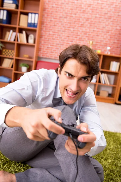Young employee playing joystick games during his break — Stock Photo, Image