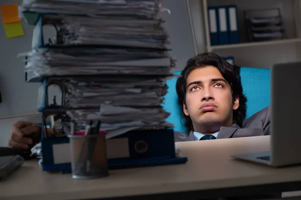 Mladý samec zaměstnanec přesčas v kanceláři — Stock fotografie
