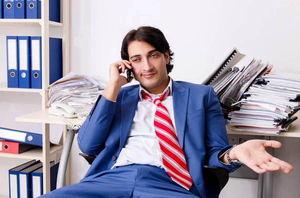 Young businessman employee unhappy with excessive work