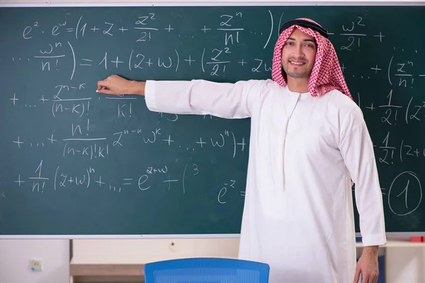 Arab teacher in front of chalkboard — Stock Photo, Image