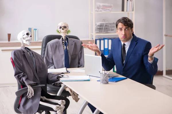 Funny business meeting with boss and skeletons