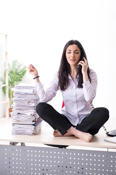 Young female employee doing exercises in the office