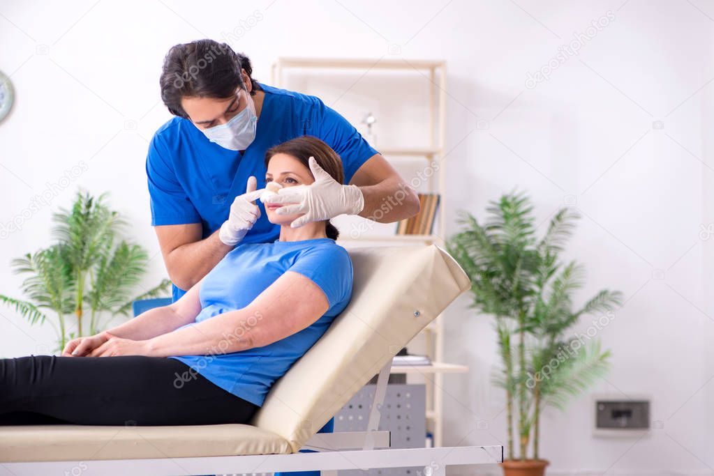 Woman visiting male doctor for plastic surgery  