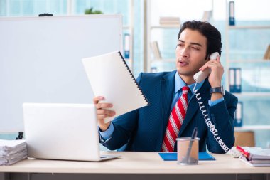 Genç yakışıklı iş adamı beyaz tahtanın önünde 