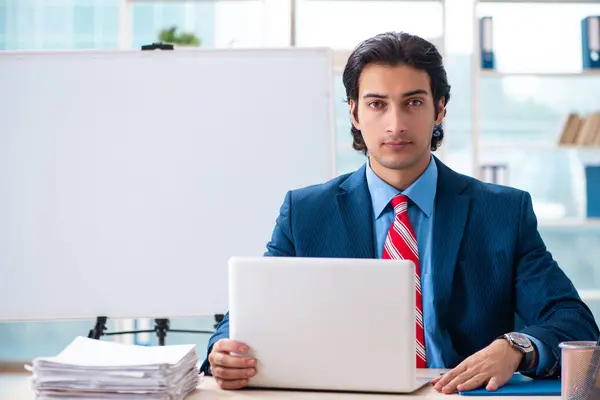 Young handsome businessman in front of whiteboard — Stock Photo, Image