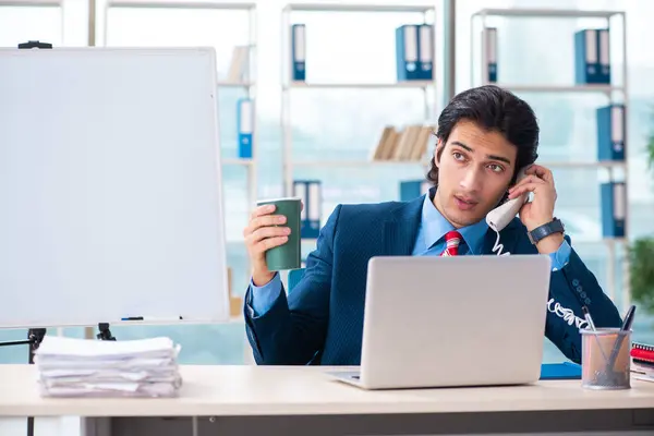 Young handsome businessman in front of whiteboard — Stock Photo, Image