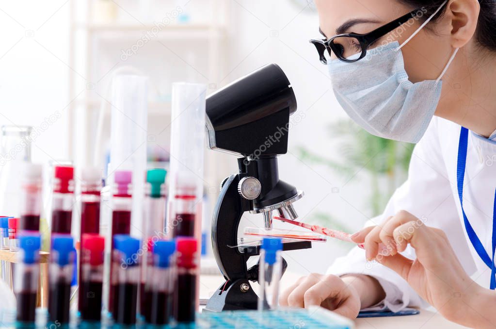 Young female chemist working in the lab 