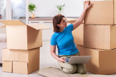 Middle-aged woman moving to new flat  clipart
