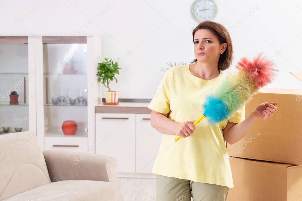 Middle-aged woman cleaning new apartment 