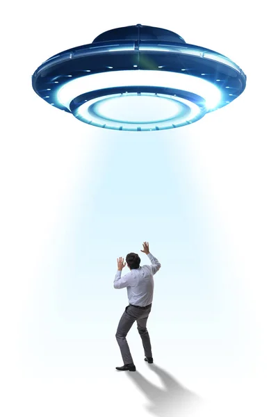 Flying saucer abducting young businessman — Stock Photo, Image