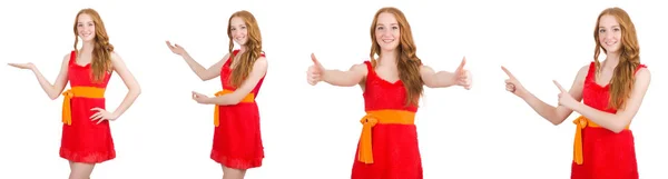 Krásná mladá dívka v červených šatech ukázala, izolované na bílém — Stock fotografie