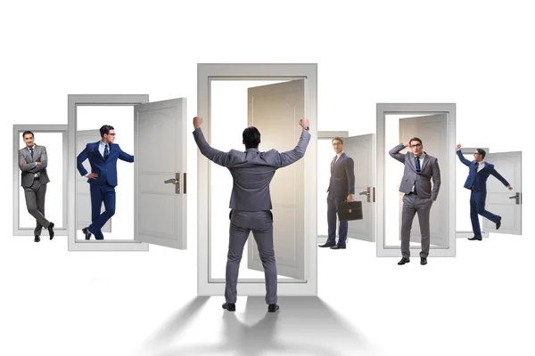 Businessman in uncertainty concept with many doors — Stock Photo, Image